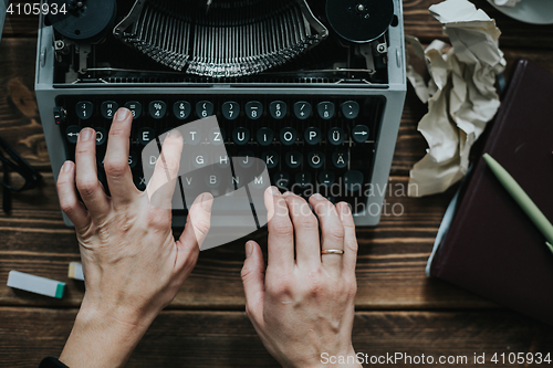 Image of Writer typing with retro writing machine.