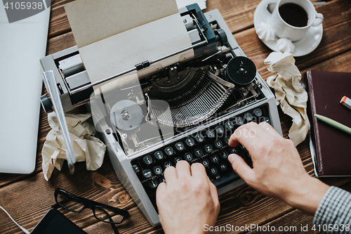 Image of Writer typing with retro writing machine.