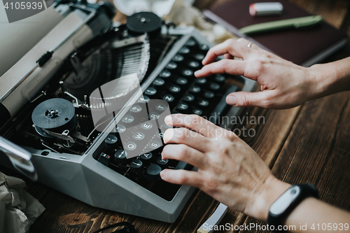 Image of Writer typing with retro writing machine.