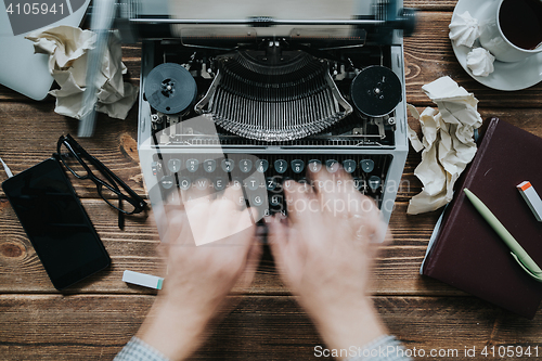 Image of Writer typing with retro writing machine.