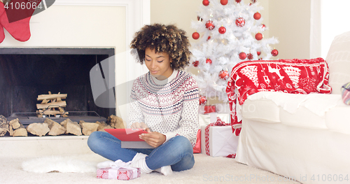 Image of Young woman surfing the internet at Christmas