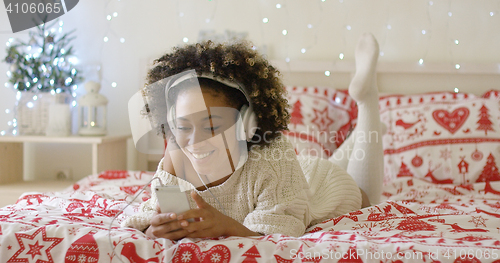 Image of Attractive young woman relaxing at Christmas