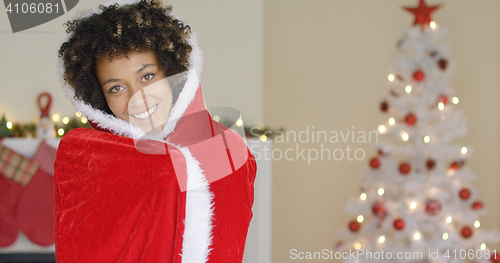 Image of Attractive woman in a red Santa cape with hood