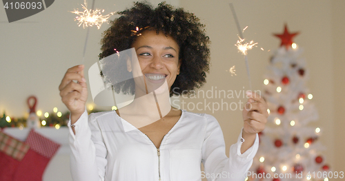 Image of Happy young woman celebrating Christmas