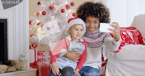 Image of Woman and child posing for camera phone