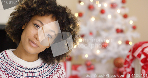 Image of Close up on grinning woman near Christmas tree
