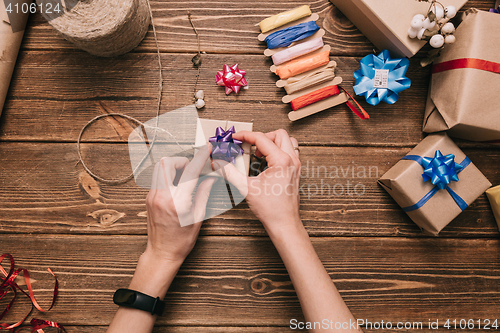 Image of Crop hands decorating present