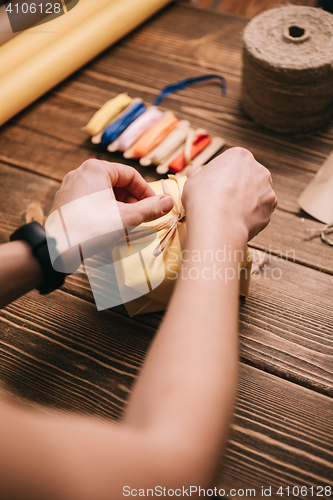 Image of Crop hands decorating present