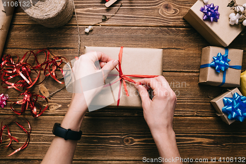 Image of Crop hands decorating present