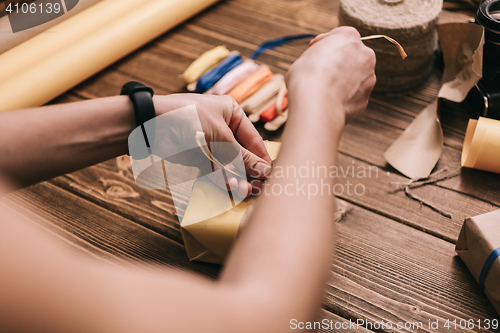 Image of Crop hands decorating present