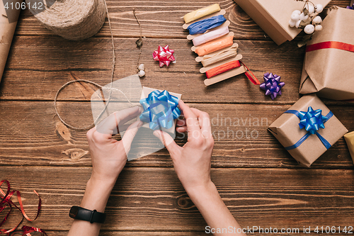 Image of Crop hands decorating present