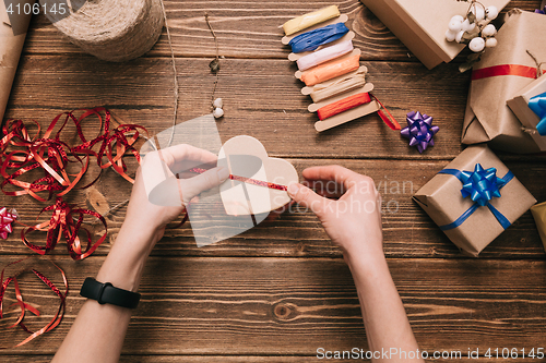 Image of Crop hands decorating present