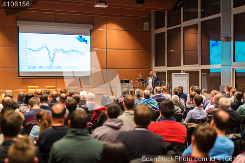 Image of Business speaker giving a talk in conference hall.