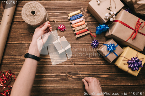 Image of Crop hands decorating present