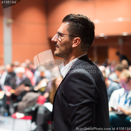 Image of Public speaker giving talk at Business Event.