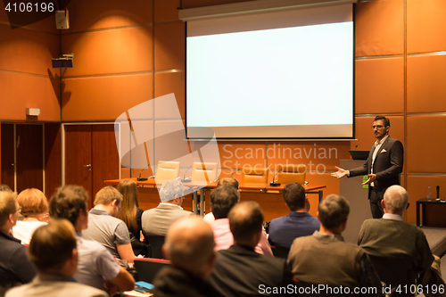 Image of Business speaker giving a talk in conference hall.