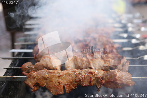 Image of Grilling marinated shashlik on a grill. Shish kebab popular in Eastern, Central Europe and other places. 