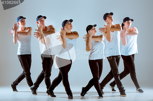 Image of Group of men and women dancing hip hop choreography