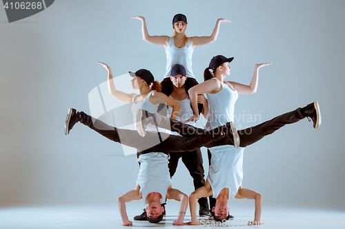 Image of Group of men and women dancing hip hop choreography