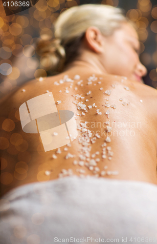 Image of close up of woman having salt massage in spa