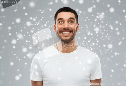 Image of man with funny face over snow