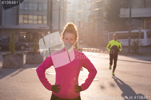 Image of woman  stretching before morning jogging