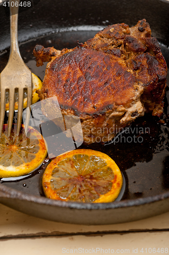 Image of pork chop seared on iron skillet