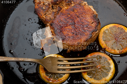 Image of pork chop seared on iron skillet