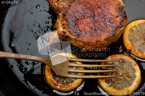 Image of pork chop seared on iron skillet