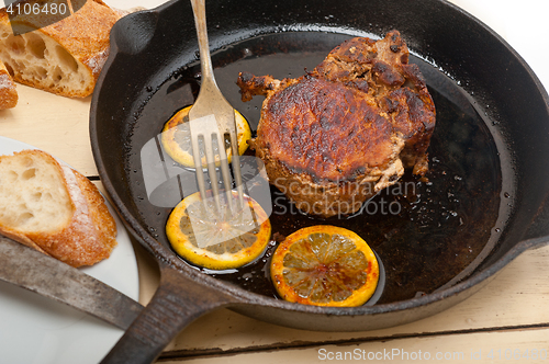 Image of pork chop seared on iron skillet