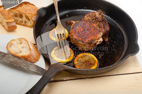 Image of pork chop seared on iron skillet