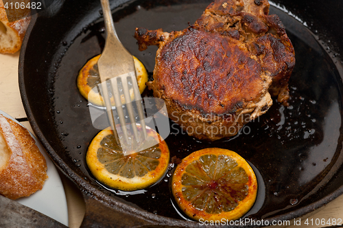 Image of pork chop seared on iron skillet