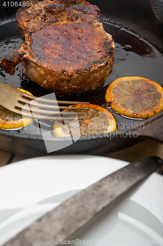 Image of pork chop seared on iron skillet