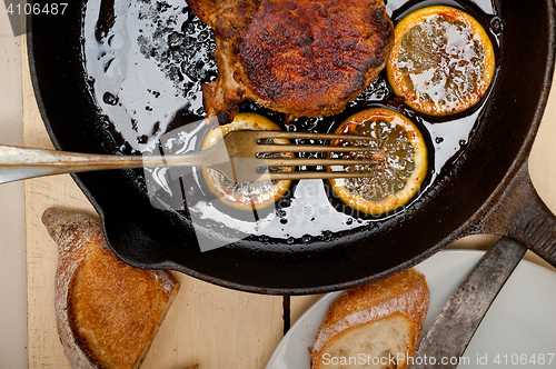 Image of pork chop seared on iron skillet