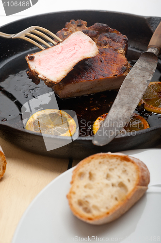 Image of pork chop seared on iron skillet