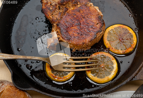 Image of pork chop seared on iron skillet