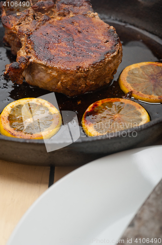 Image of pork chop seared on iron skillet