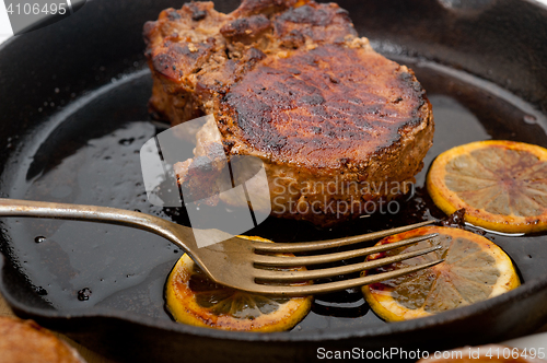 Image of pork chop seared on iron skillet