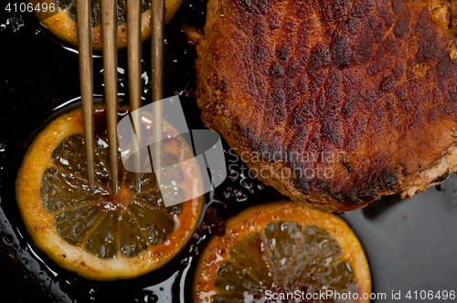 Image of pork chop seared on iron skillet