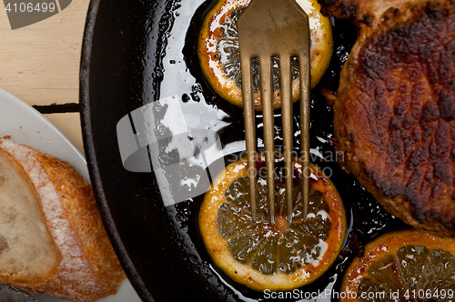 Image of pork chop seared on iron skillet