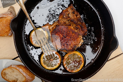 Image of pork chop seared on iron skillet