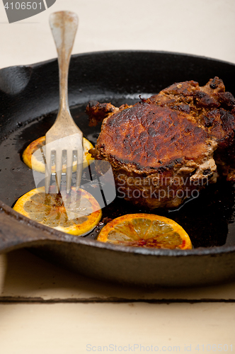 Image of pork chop seared on iron skillet