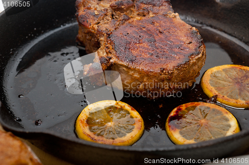 Image of pork chop seared on iron skillet