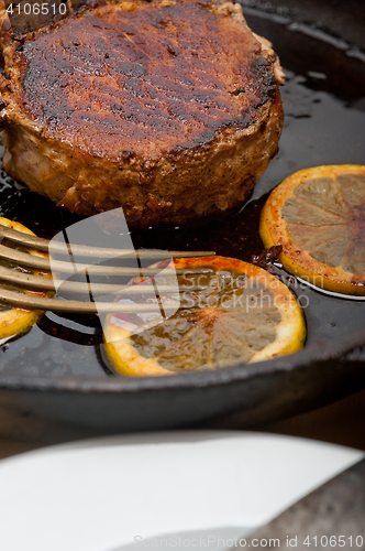 Image of pork chop seared on iron skillet