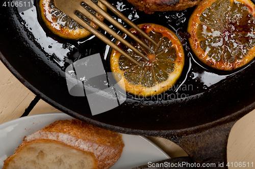 Image of pork chop seared on iron skillet