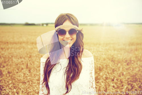 Image of smiling young hippie woman on cereal field