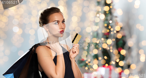 Image of woman with bank card and shopping bags