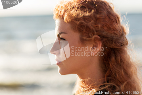 Image of happy young redhead woman face on beach