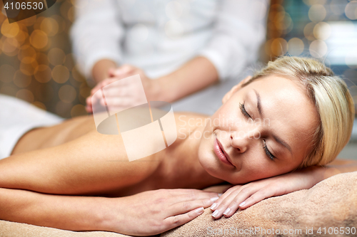 Image of close up of woman lying and having massage in spa