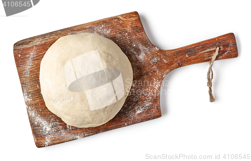 Image of fresh raw dough on wooden board